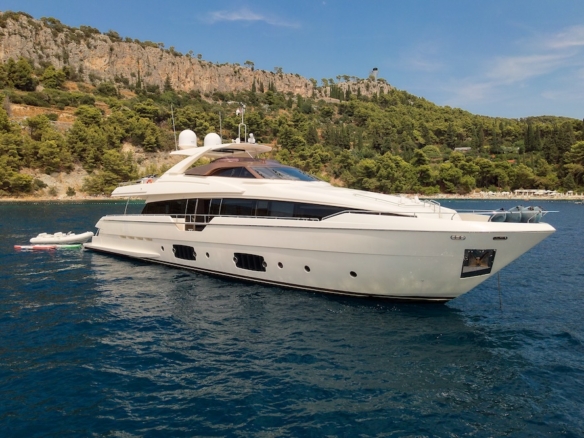 IVA yacht exterior side profile anchored in calm Mediterranean waters with surrounding coastline