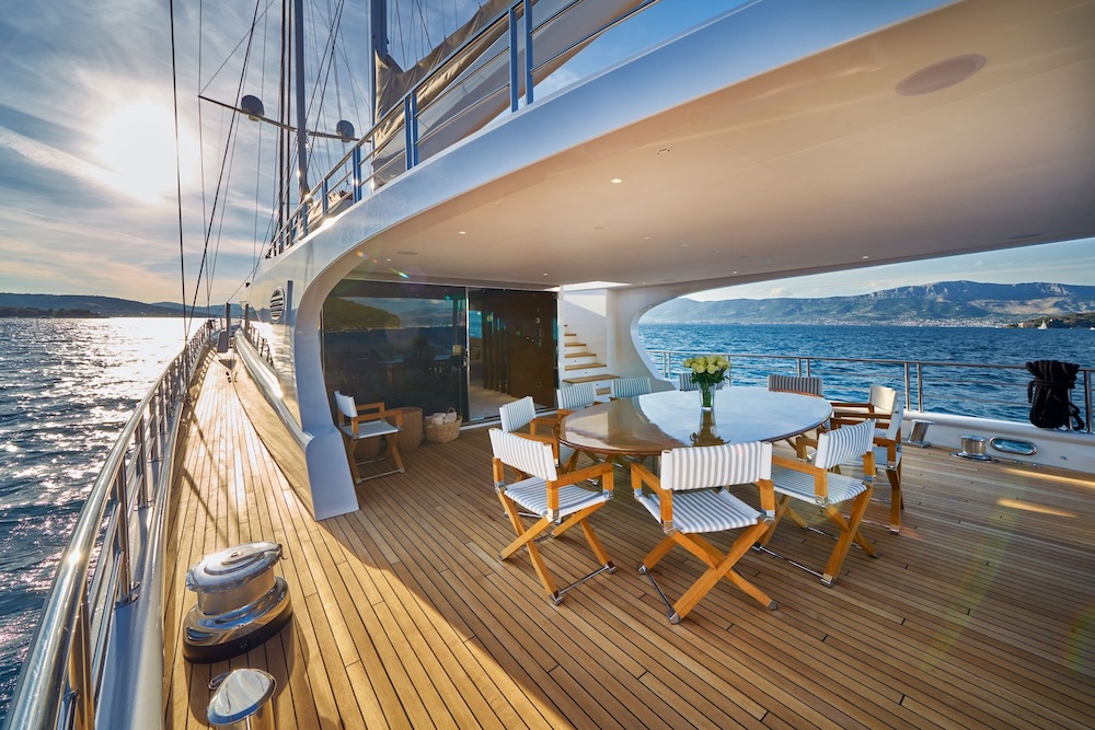 Acapella yacht aft deck at sunset with outdoor dining and sea views