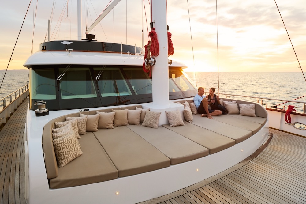 Love Story yacht anchored in a quiet bay at sunset with calm water and soft evening light