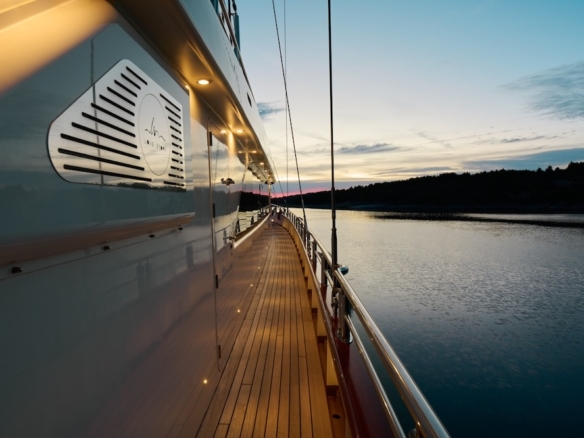 Yacht at anchor in calm sea during golden hour with open horizon