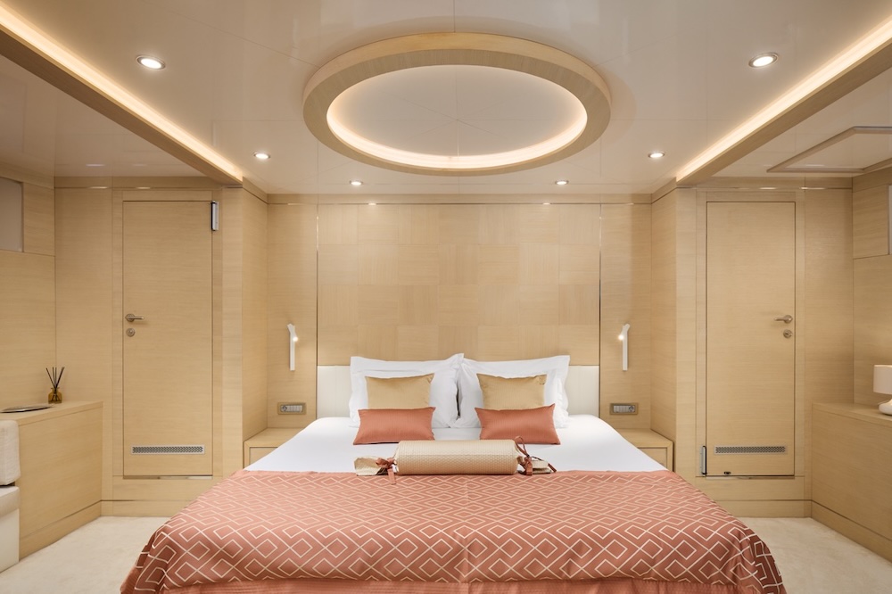 Master cabin on Love Story yacht with warm wood tones and soft lighting