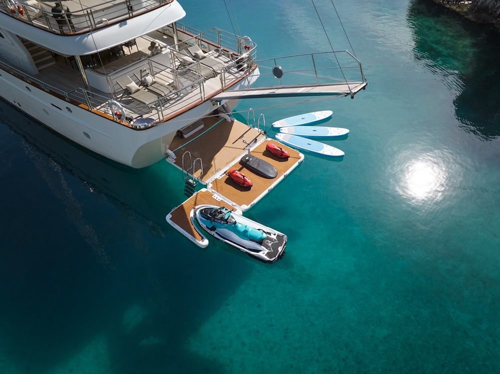 Water sports platform on Love Story yacht with jet ski paddleboards and clear water