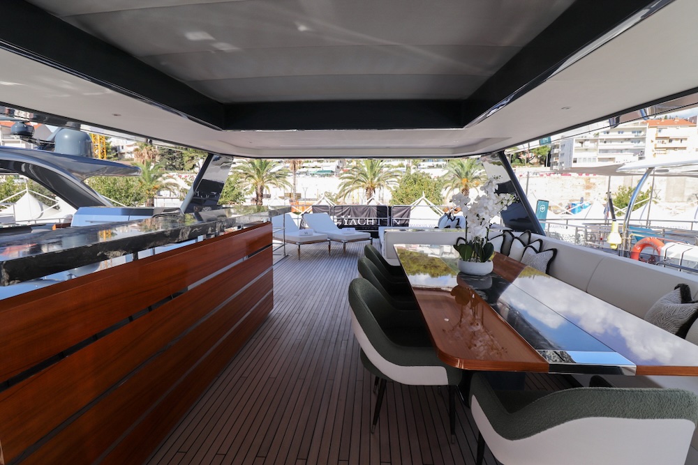Alt text: Aft deck lounge area on Majera yacht with shaded seating and open layout