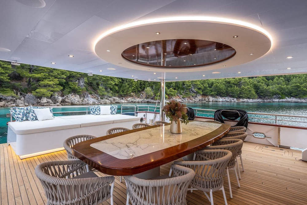 Bright salon aboard S/Y Nocturno with open-plan seating and soft natural light