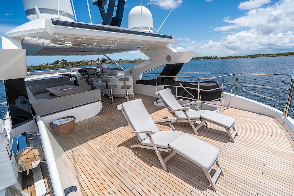 Sun loungers on the upper deck of Quantum yacht with open ocean views and relaxed seating area
