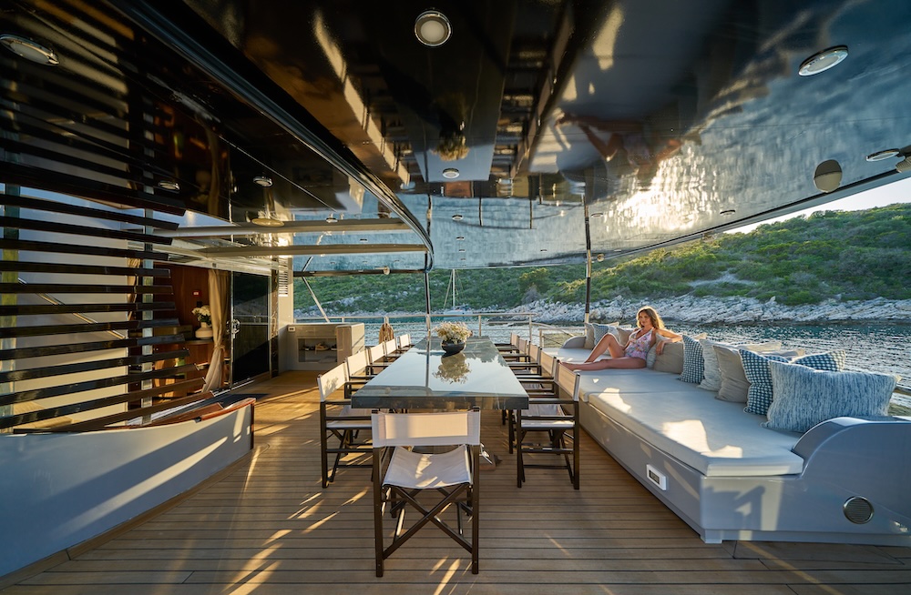 Inviting aft deck dining and lounge area prepared for guests on board Rara Avis