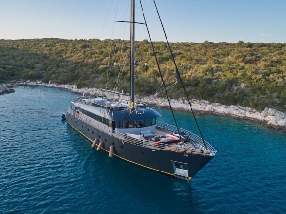 Rara Avis motor sailer anchored in a secluded Adriatic bay with clear blue water