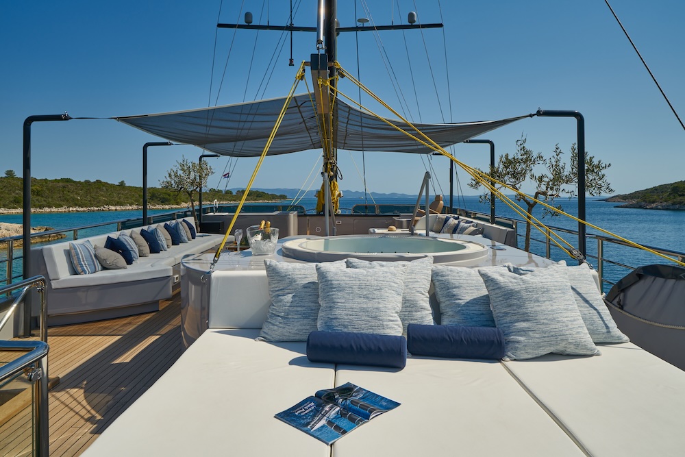 Spacious sundeck on Rara Avis with lounge seating and jacuzzi overlooking the sea