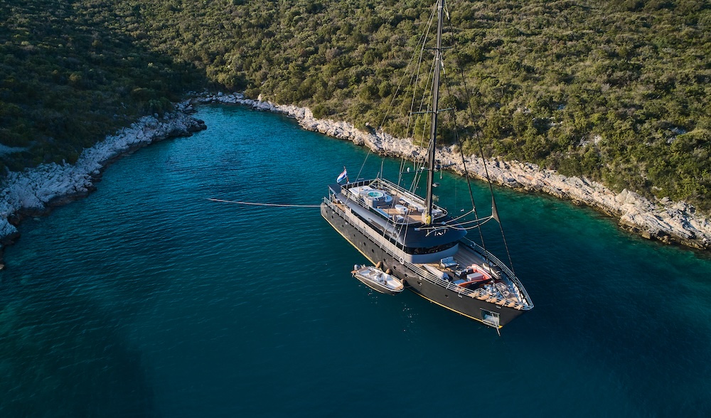 Tender boat alongside Rara Avis yacht in clear water ready for coastal exploration