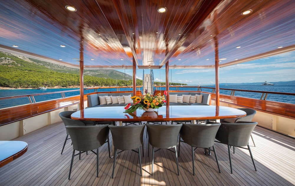 Aft deck dining area on Son de Mar with panoramic sea views