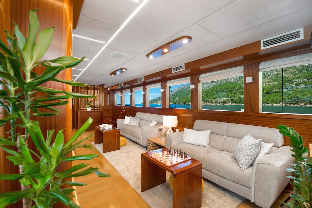 Interior salon of Son de Mar with lounge seating and large windows