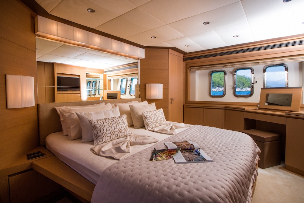 Master cabin on yacht SALT with soft lighting and wood finishes