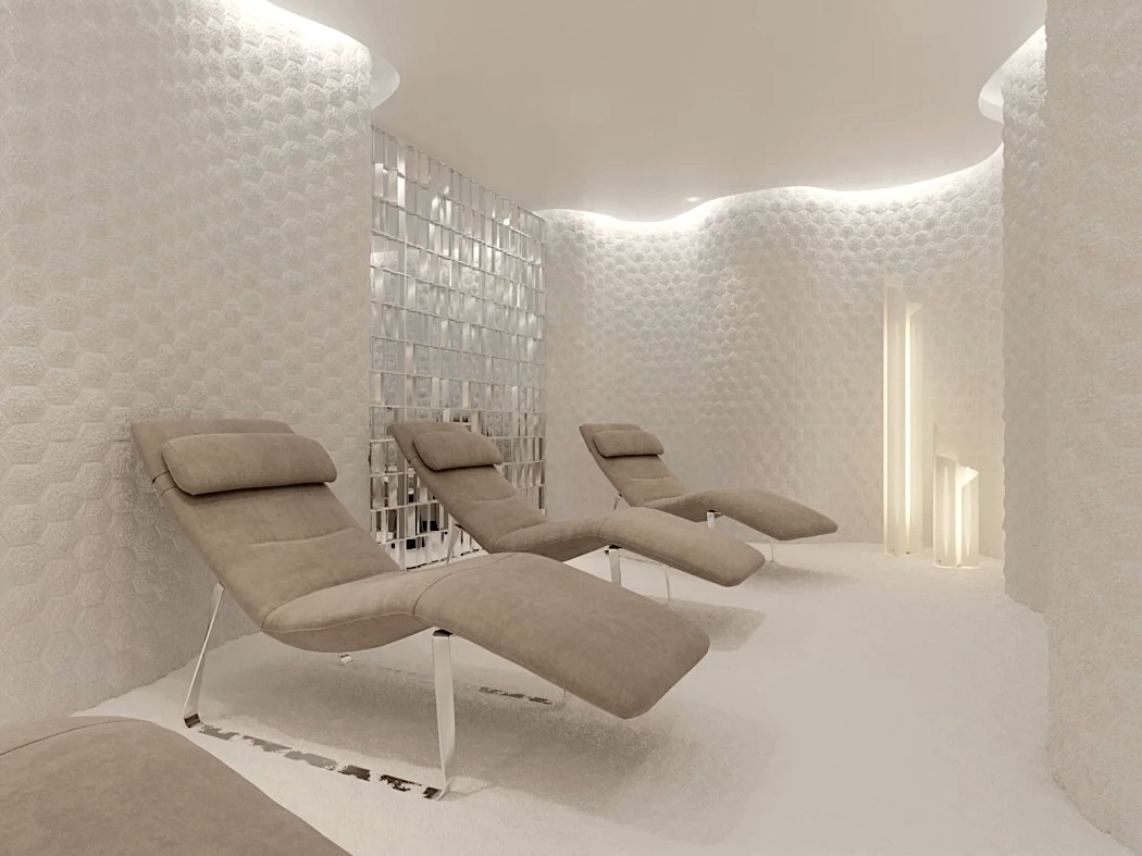 Contemporary mineral wellness room with softly illuminated hexagonal white salt walls and reclining lounge chairs