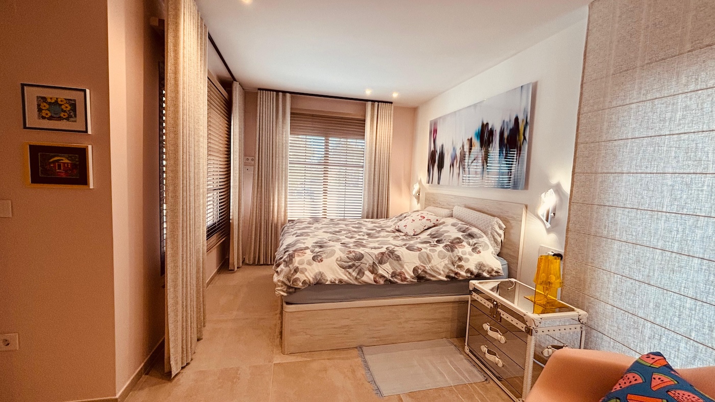 Comfortable bedroom with natural light and soft coastal interior tones