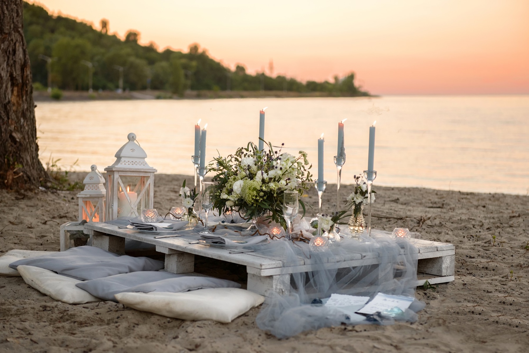 Elegant beach dinner setting beside the sea designed for retreats and private celebrations
