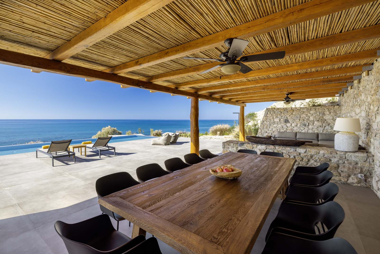 Covered outdoor lounge overlooking the sea at Beach House Arvi East