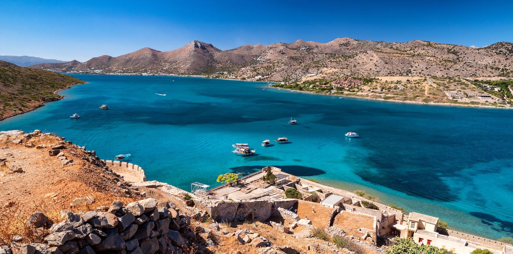 Turquoise coastline and rugged Mediterranean landscape near Spinalonga in Crete