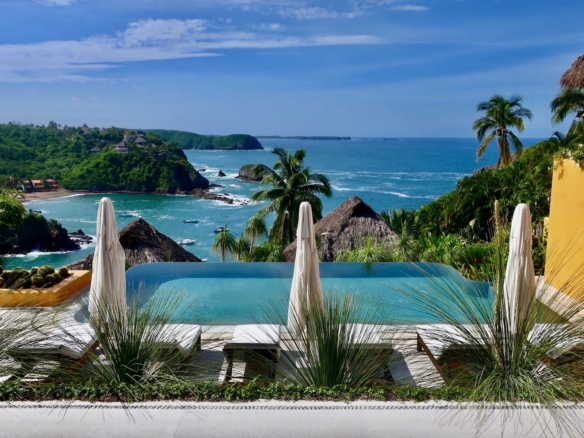 Infinity pool at Casa Torre overlooking the Pacific Ocean and coastline in Careyes, Mexico