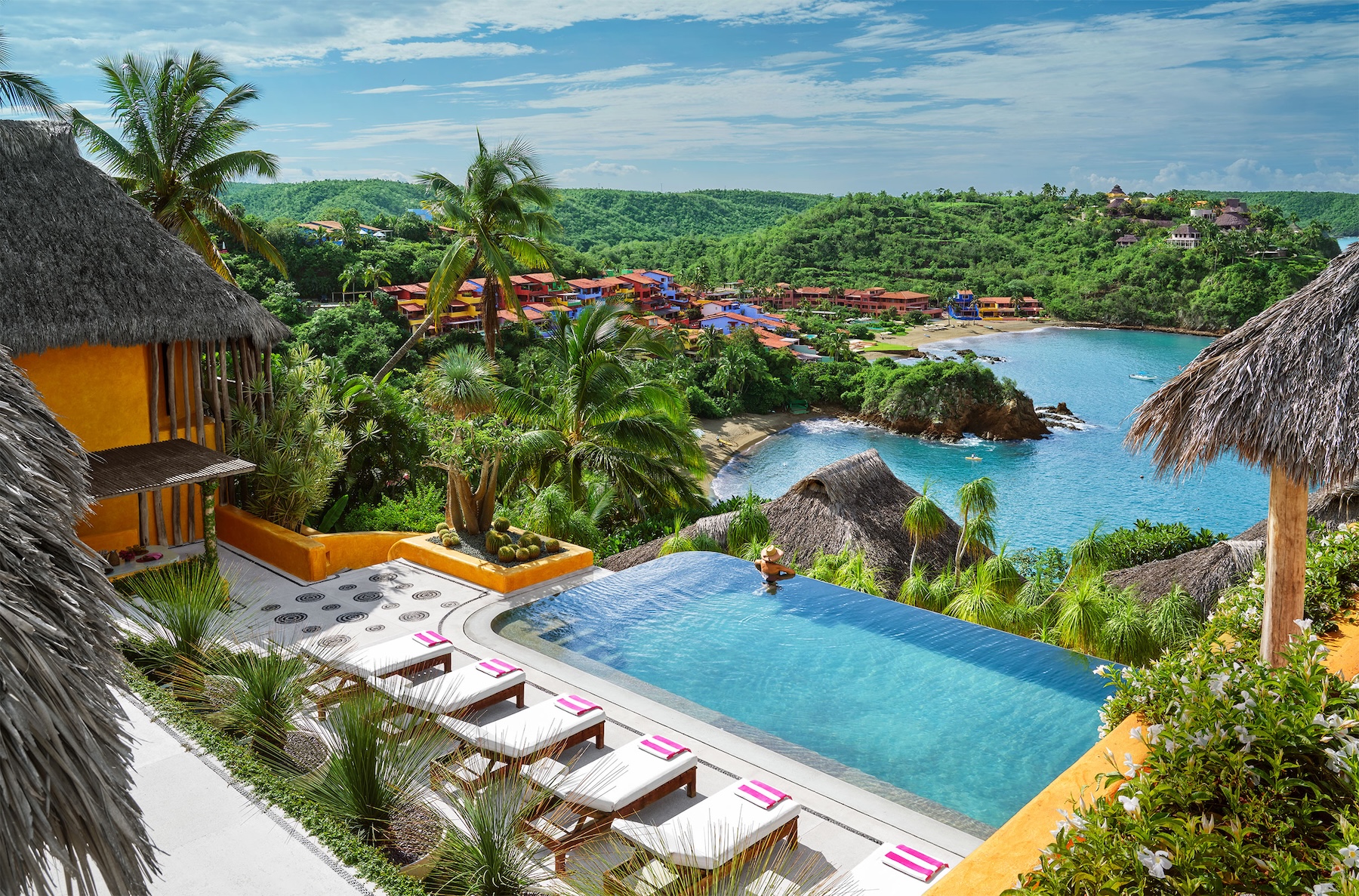 Infinity pool and sun terrace at Casa Torre overlooking the Pacific coastline and Careyes, Mexico.