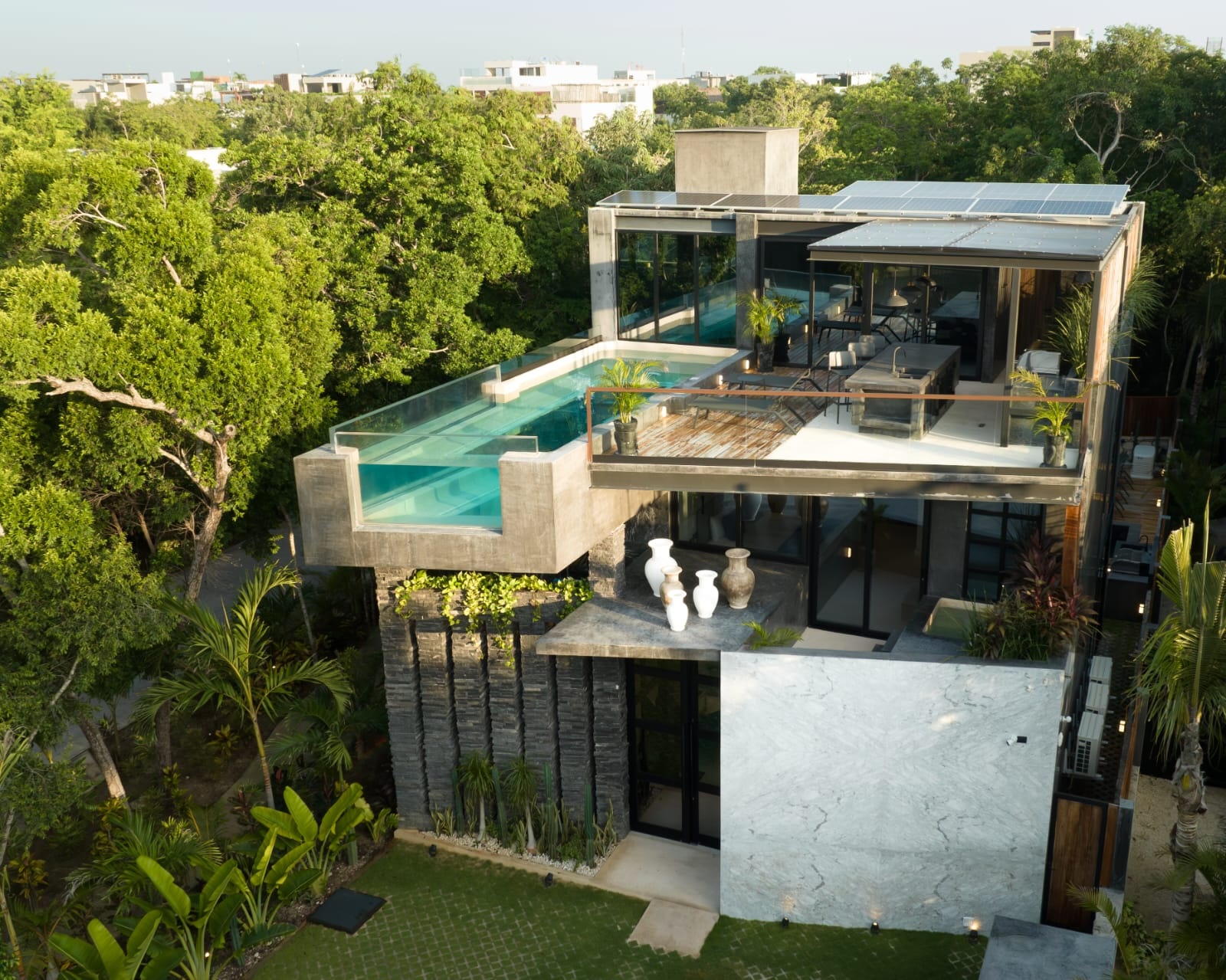 Contemporary home with rooftop infinity pool surrounded by tropical greenery in Tulum, Mexico