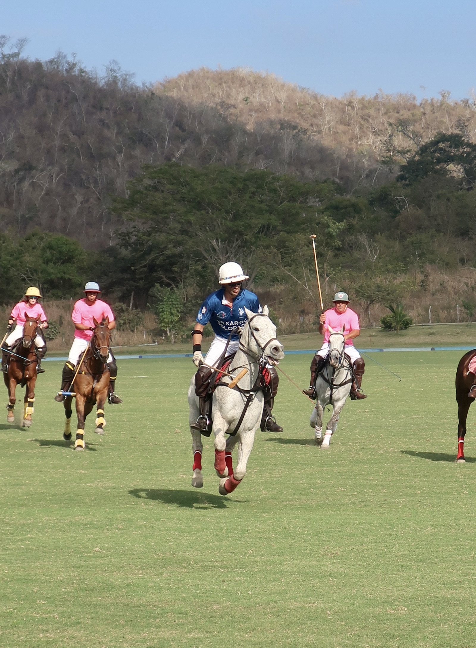 Polo players on horseback during a match in Careyes, Mexico