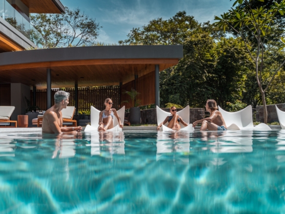 Family relaxing together in the pool at Villa Avellana in Peninsula Papagayo, Costa Rica.