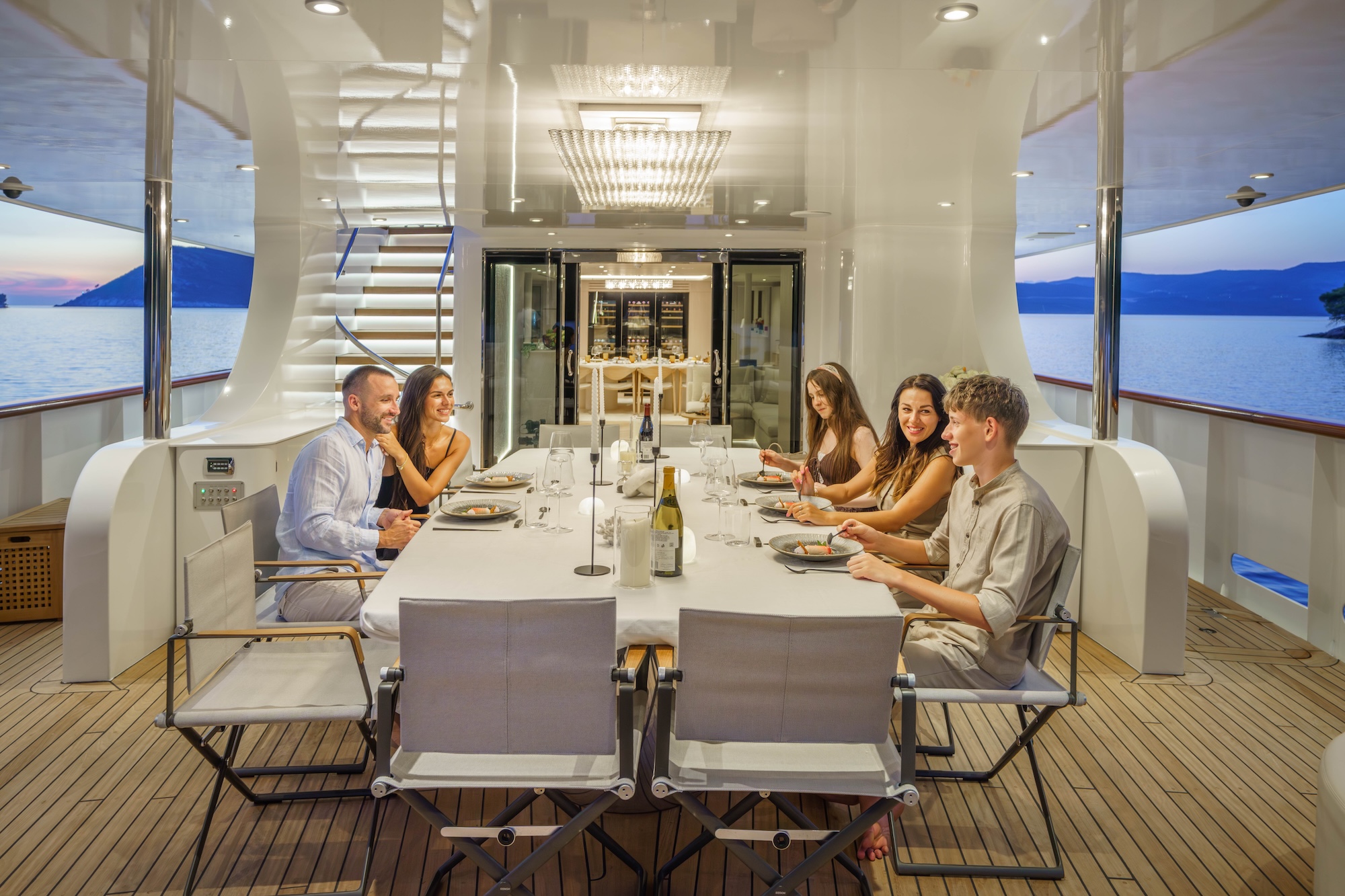 Family dining on the aft deck of a private charter yacht